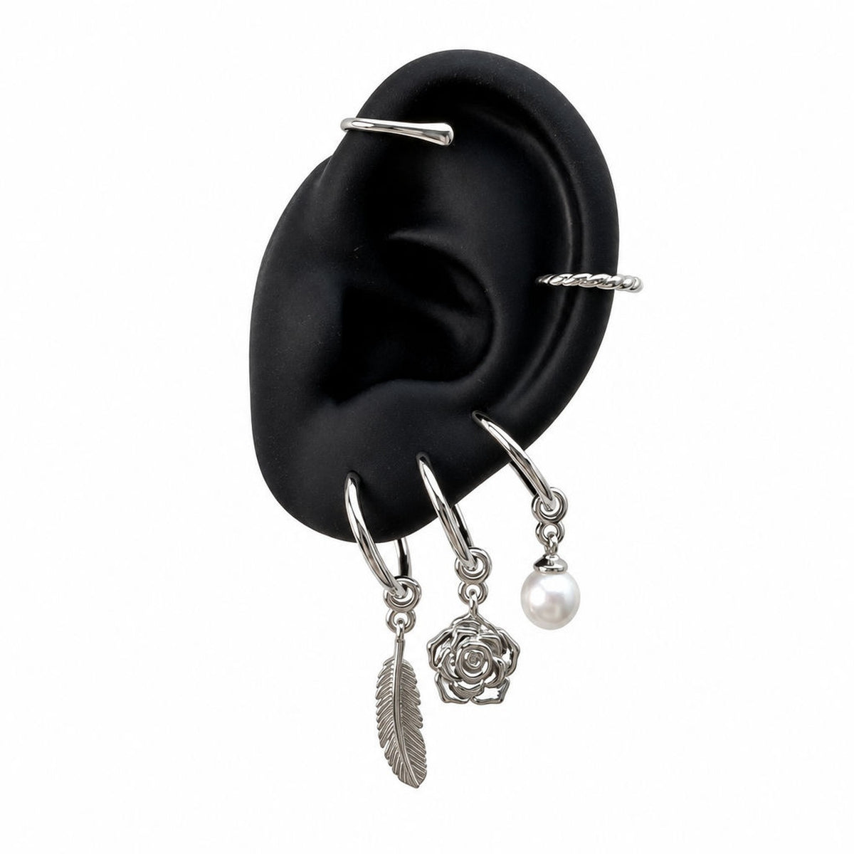 Silver Charm Cuff with feather, rose and pearl charms on display ear