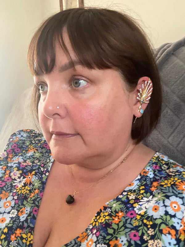 An Oreylo customer wearing their earrings